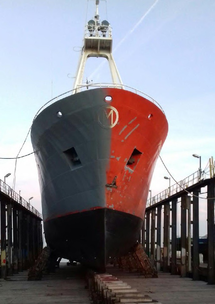 Polarfront’s bow in dry dock, half repainted gray, half still red